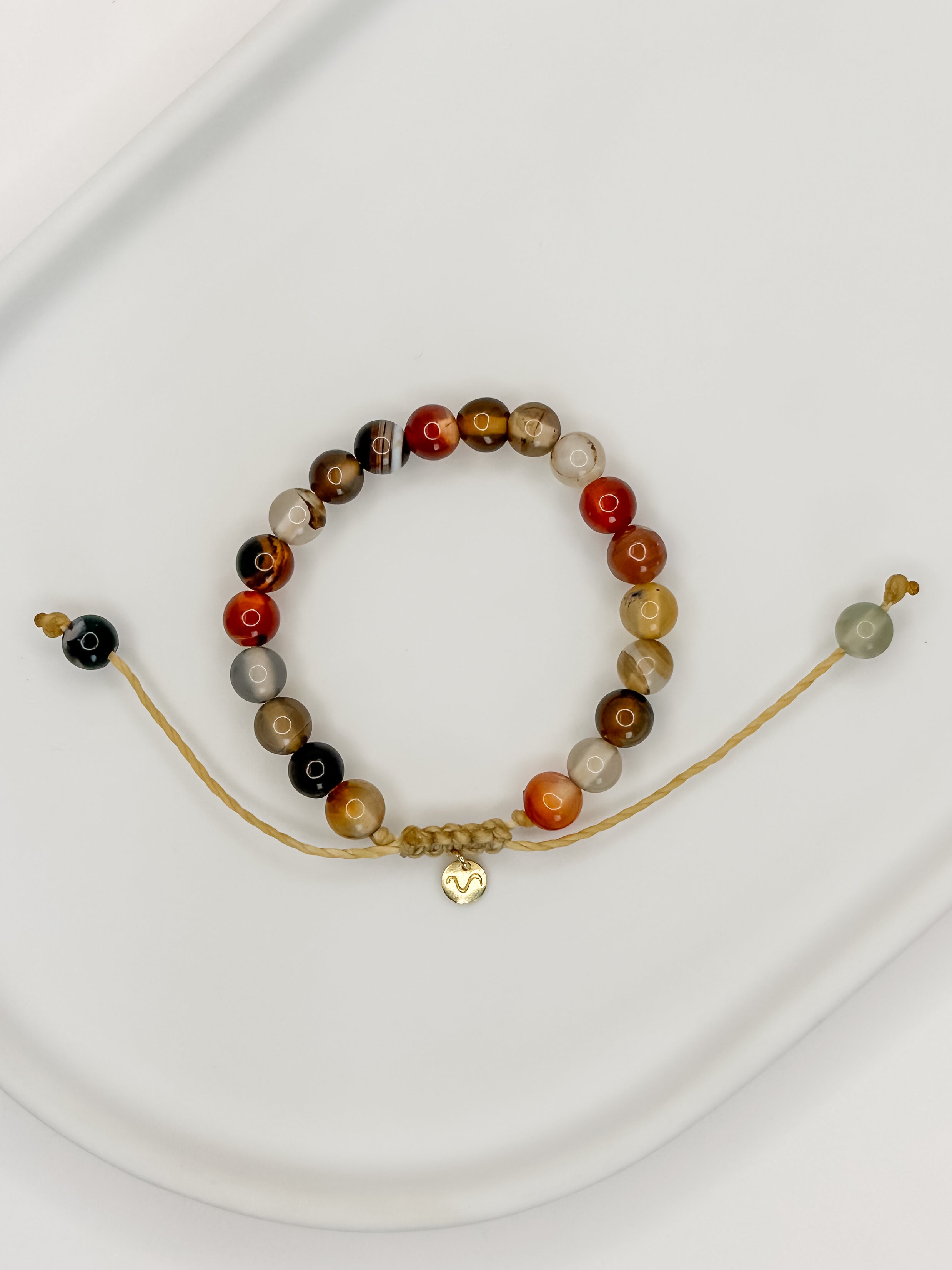 Pulseira de corda tamanho único com esferas de 6mm de ágata natural em bandeja branca com fundo branco.